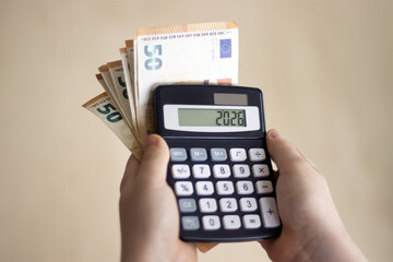 Child calculating money using a calculator