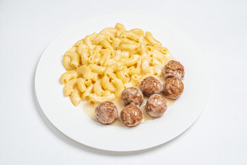 Delicious macaroni and cheese paired with juicy meatballs creates a comforting meal