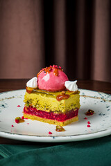 A vibrant, multi-layered cake on a fine plate beckons for indulgence