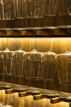 Wine glasses shimmer softly under warm lights, creating a welcoming atmosphere for evening diners