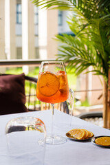 A colorful drink rests on the table, garnished with bright orange slices, inviting relaxation