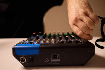 Closeup of tactile controls and vibrant patch cords in studio, Adjusting analog sequencing equipment with bright cables and warm ambient lighting in home studio
