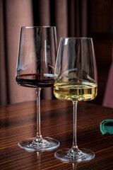 Two stunning glasses hold red and white wine, highlighting their rich colors and inviting aromas