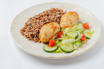 A delicious plate displays tender chicken, nutty bulgur wheat, and vibrant salad, evoking comfort