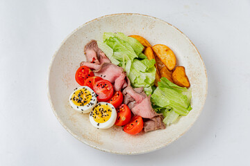 Tasty salad with tender beef, crisp lettuce, tomatoes, and boiled eggs for a vibrant bite