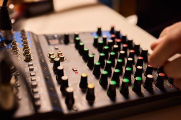 Closeup of tactile controls and vibrant patch cords in studio, Adjusting analog sequencing equipment with bright cables and warm ambient lighting in home studio
