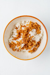 A bowl of steamed rice topped with crispy fried onions for a savory delight