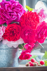Colorful roses bloom in a rustic vase, adding life to a bright kitchen filled with natural light