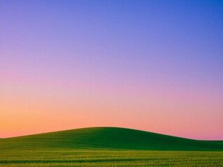 Obraz premium Person standing on a hill during sunset with colorful sky in the background showing gradients of orange and blue