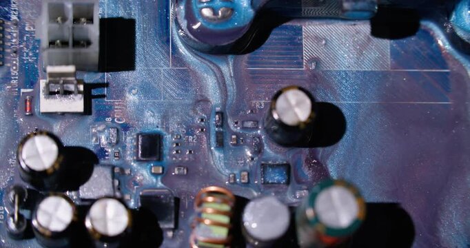 Ink pour. Electronic abstraction. Defocused blue white purple colorful glitter water round microcircuit wet flow on digital art background.