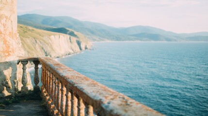 Obraz premium View of ocean and mountains from a stone railing near the coast