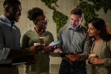 Diverse business team collaborating on tablet in office