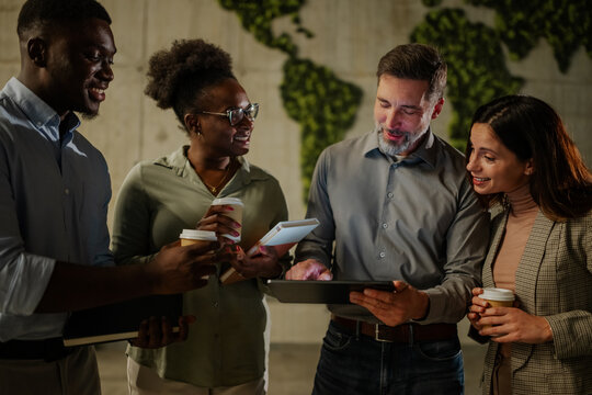 Diverse business team collaborating on tablet in office