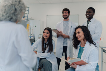 Science students listening to teacher in laboratory