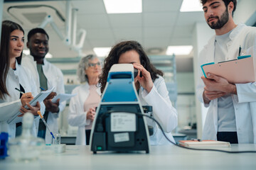 Naklejka premium Science students using microscope in laboratory research