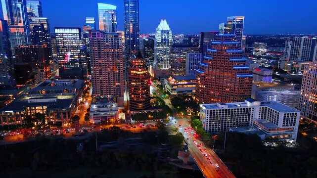 Hectic traffic on the roads and bridges at night. Luminous scenery of Austin, Texas, USA from aerial view.