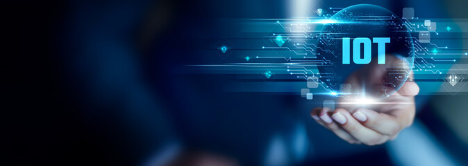 IOT concept, Businessman hold IOT text. connected devices, smart networks, real-time data, automation systems, remote monitoring, intelligent communication