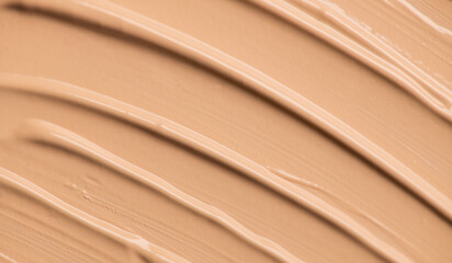 Foundation, concealer, face makeup smudge, smears background. Cosmetic liquid foundation or cream beige color smudges, stroke. Contouring, Make up. Foundation texture surface, backdrop