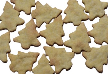 Playful arrangement of baked Christmas tree cookies on a white background. Crispy golden homemade treats perfect for festive design, packaging, menu layouts, and seasonal holiday imagery.
