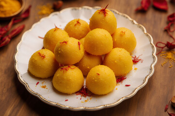 Traditional yellow Indian sweets for festival. Cultural dessert photography.