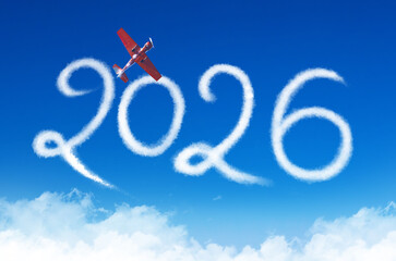 Happy New year 2026 concept travel on the background below cloudscape. Drawing by red turboprop airplane vapor contrail in sky.