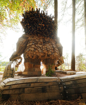 Raleigh, NC - USA - 11-26-2025: "Dix" troll sculpture by artist Thomas Dambo, made with reaclaimed wood and recycled bourbon barrels,  at Dix Park near downtown Raleigh