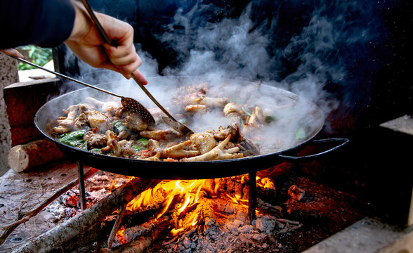 Traditional Valencian paella cooking process: preparing the tomato sofrito base &ndash; Mediterranean cuisine in Spain.