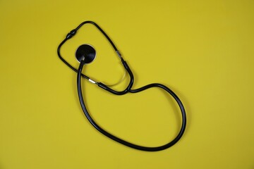 Stethoscope On yellow Surface. Medical Equipment For Health Care And Diagnosis