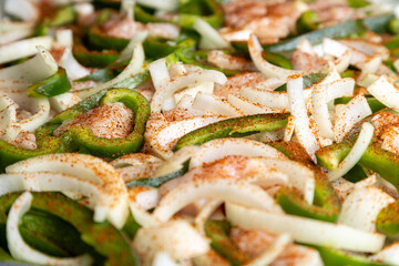 Sheet pan chicken fajitas with sliced onions, green bell peppers, and seasoned chicken arranged on a baking tray. Fresh, simple, and perfect for meal prep or easy dinner recipes.