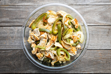 Sheet pan chicken fajitas with sliced onions, green bell peppers, and seasoned chicken arranged on a baking tray. Fresh, simple, and perfect for meal prep or easy dinner recipes.