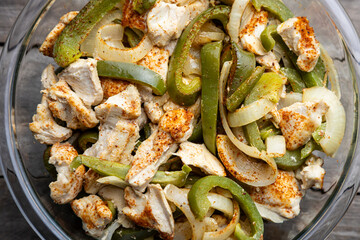 Sheet pan chicken fajitas with sliced onions, green bell peppers, and seasoned chicken arranged on a baking tray. Fresh, simple, and perfect for meal prep or easy dinner recipes.