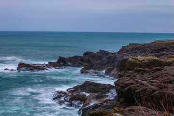 Rocky Pacific Coastline with Long Exposure Waves and Seabirds. Rocky Pacific Coastline with Long Exposure Waves and Seabirds.