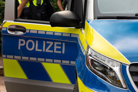 The open door of a German police car with the sign "Polizei." Background for breaking news, events, incidents, breaking news, traffic accidents, fires, and city news.