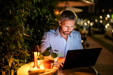 Businessman working on laptop outdoor. Business man having video laptop call communication. Business man working online. Successful businessman freelancing online. Business success