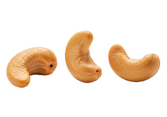 Fototapeta premium Three individual golden-brown roasted cashew nuts with natural texture, soft shadows, on a transparent background with copy space, 3/4 view. Concept of healthy premium snack