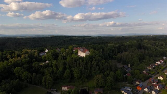 Flying over Alt-Ortenburg Castle in Ortenburg, Bavaria. Historic hilltop castle with preserved architecture, museum and aerial views of Passau countryside. Luftaufnahme Schloss Ortenburg, Deutschland