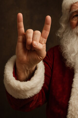 Santa Claus is ready to rock and roll this holiday season! He's spreading joy and headbanging with a metal hand gesture. Happy Holidays!