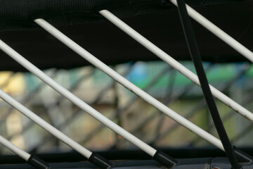 Angled support with dynamic background, Blurred background highlights support rods in action, Dynamic perspective showcasing support rods with vibrant highlights and lively sports environment