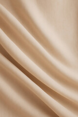 Fototapeta premium Smooth, light beige fabric with flowing, gentle folds. The soft, neutral tone creates a calming and elegant texture ideal for various designs.