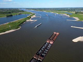 Aerial view of a pusher tug transporting coal on the Waal river to Germany, Rossum, The Netherlands