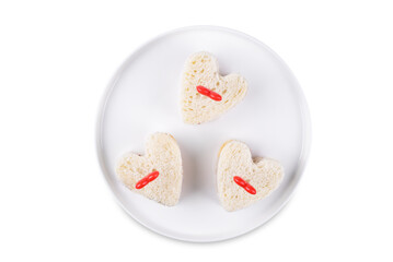 Sandwiches with berries jam in the form of hearts for Valentine's day holidays on a white isolated background
