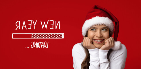 A young girl wearing a festive Santa hat excitedly waits for the New Year. She smiles brightly, holding her cheeks with joy, against a vivid red background.