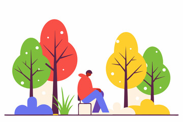 Mężczyzna siedzący w kolorowym jesiennym parku wśród drzew i krzewów.