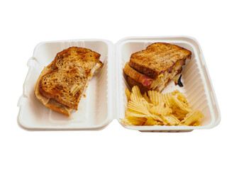 Premium toasted sandwich with crisps in a white take away plastic container on white background. Office lunch or breakfast. Easy light meal.