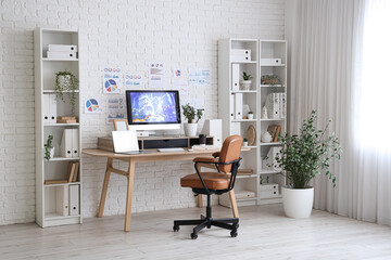 Interior of data scientist's office with workplace, diagrams and shelf units
