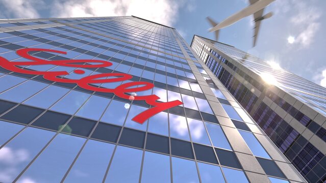 Eli Lilly signature floating across a mirrored highrise facade, in an illustrative editorial 3d rendering