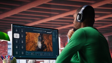 Videographer editor creates AI art materials using text to video software, writing a text prompt on...