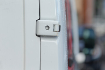 Close view of textured water droplets hinge, Close shot showing metallic hinge with beads and water droplets, Detailed closeup of metal hinge textured with beads and tiny water droplets