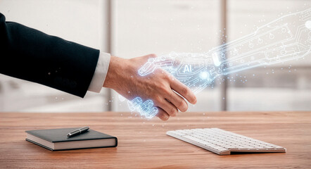 Businessman shaking hands with a holographic AI robot arm, symbolizing innovation, digital collaboration, and the partnership between humans and artificial intelligence in modern workplaces