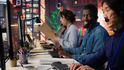 Customer service agent answer customer questions related to products or services. Call center employee managing incoming and outgoing calls, handling customer complaints, camera B